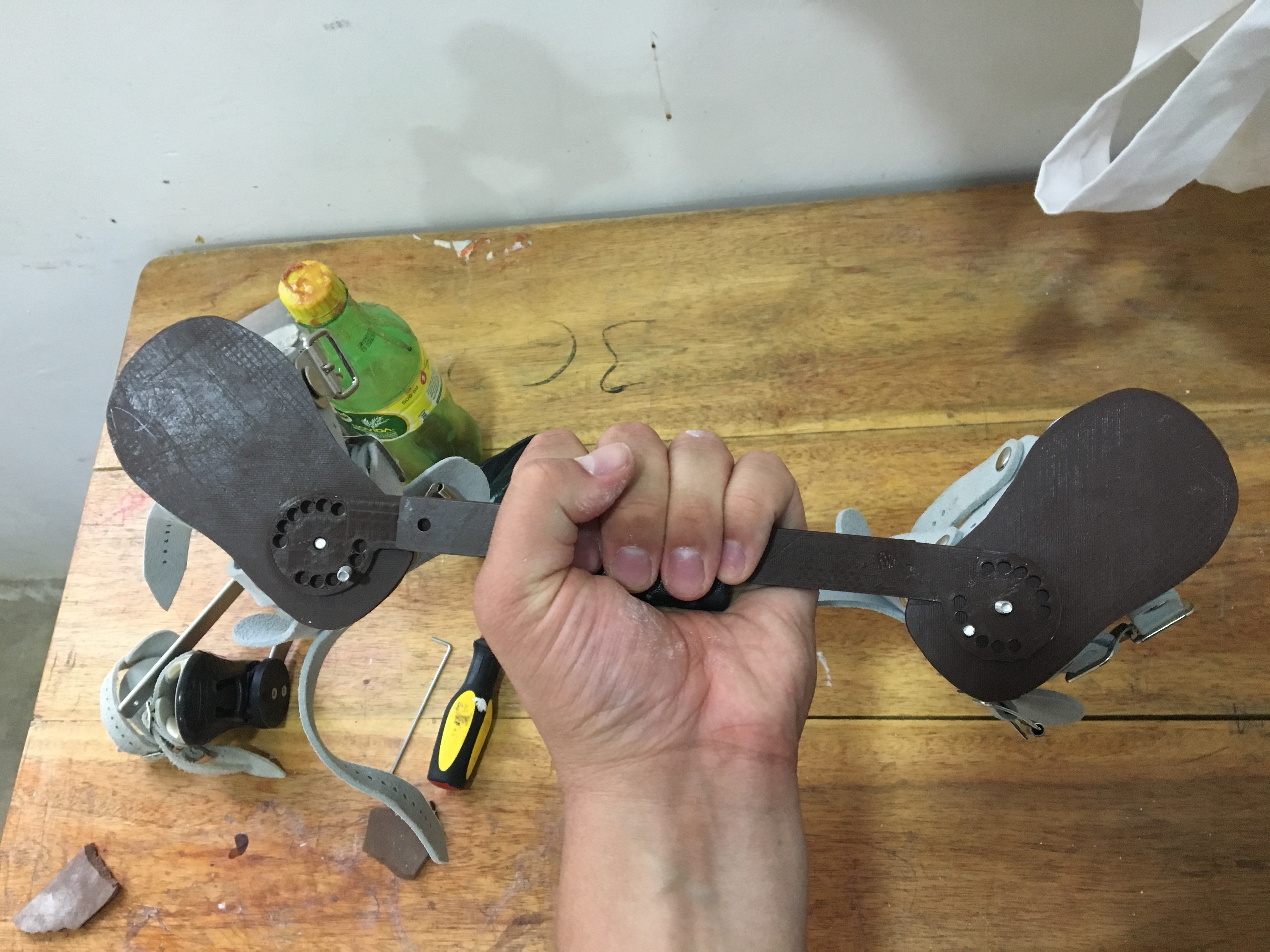 A 3D printed bar attached to low-cost foot abduction brace boots. 